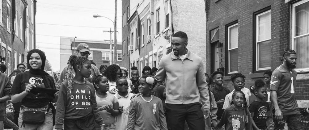 Jalen Hurts Foundation walking, black and white photo